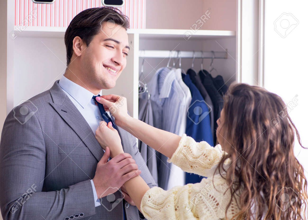 150409150-wife-helping-husband-to-get-dressed-up